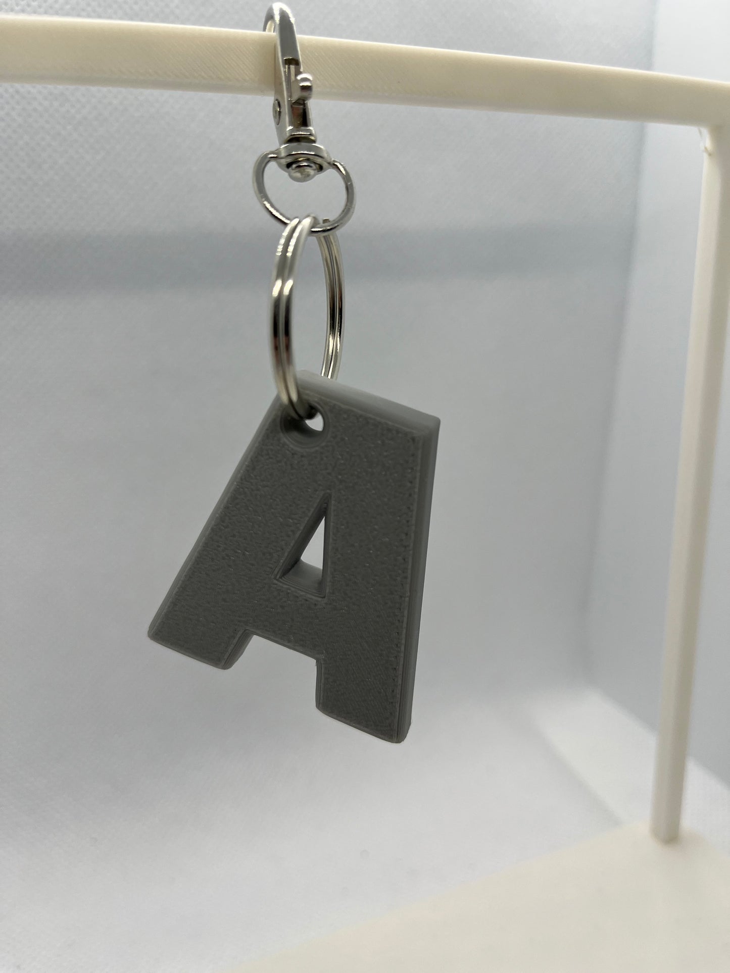 Grey Keychain with a letter 'A' on a white background