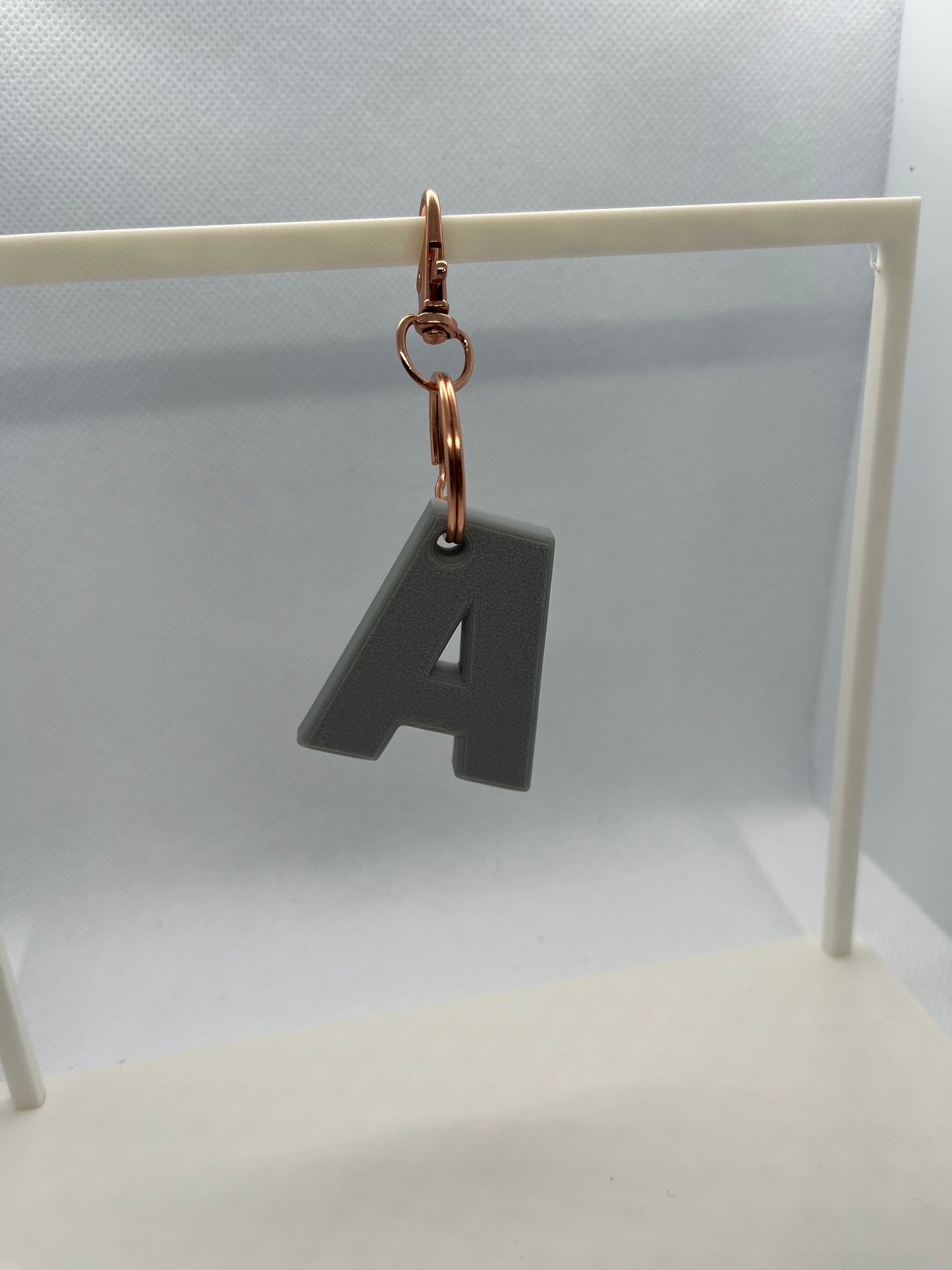 Grey Keyring with a letter 'A' charm on a neutral background