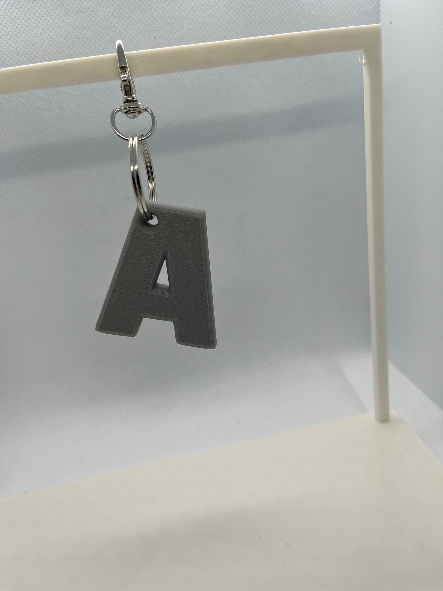 Grey Keychain with letter 'A' on a white background