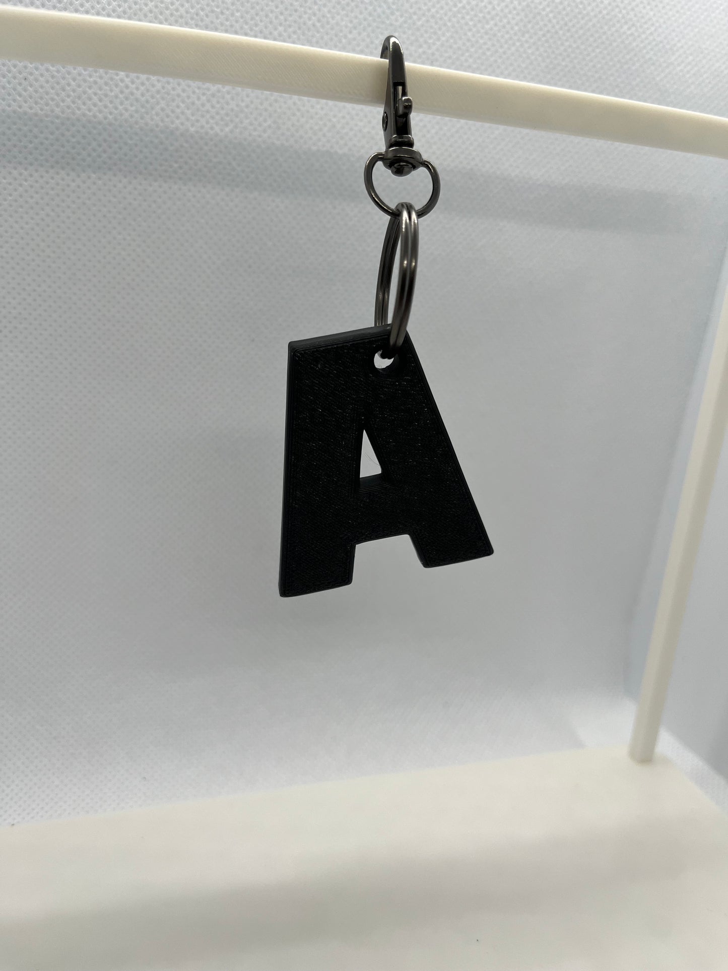 Black letter 'A' keychain on a white background