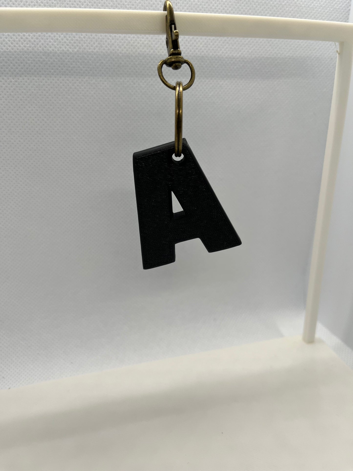 Black letter 'A' keychain on a white background