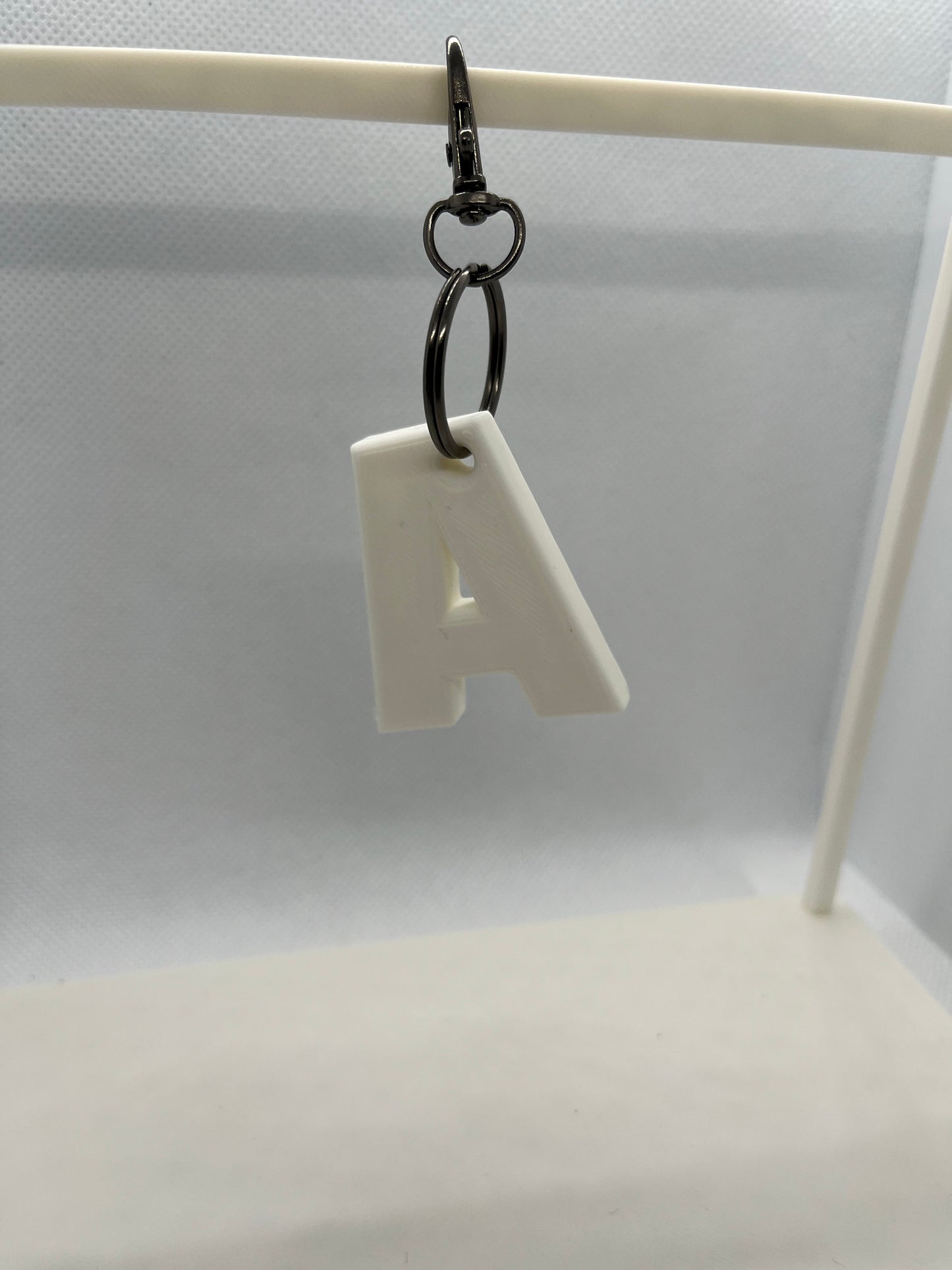 White Letter A with a key attached to it on a white background