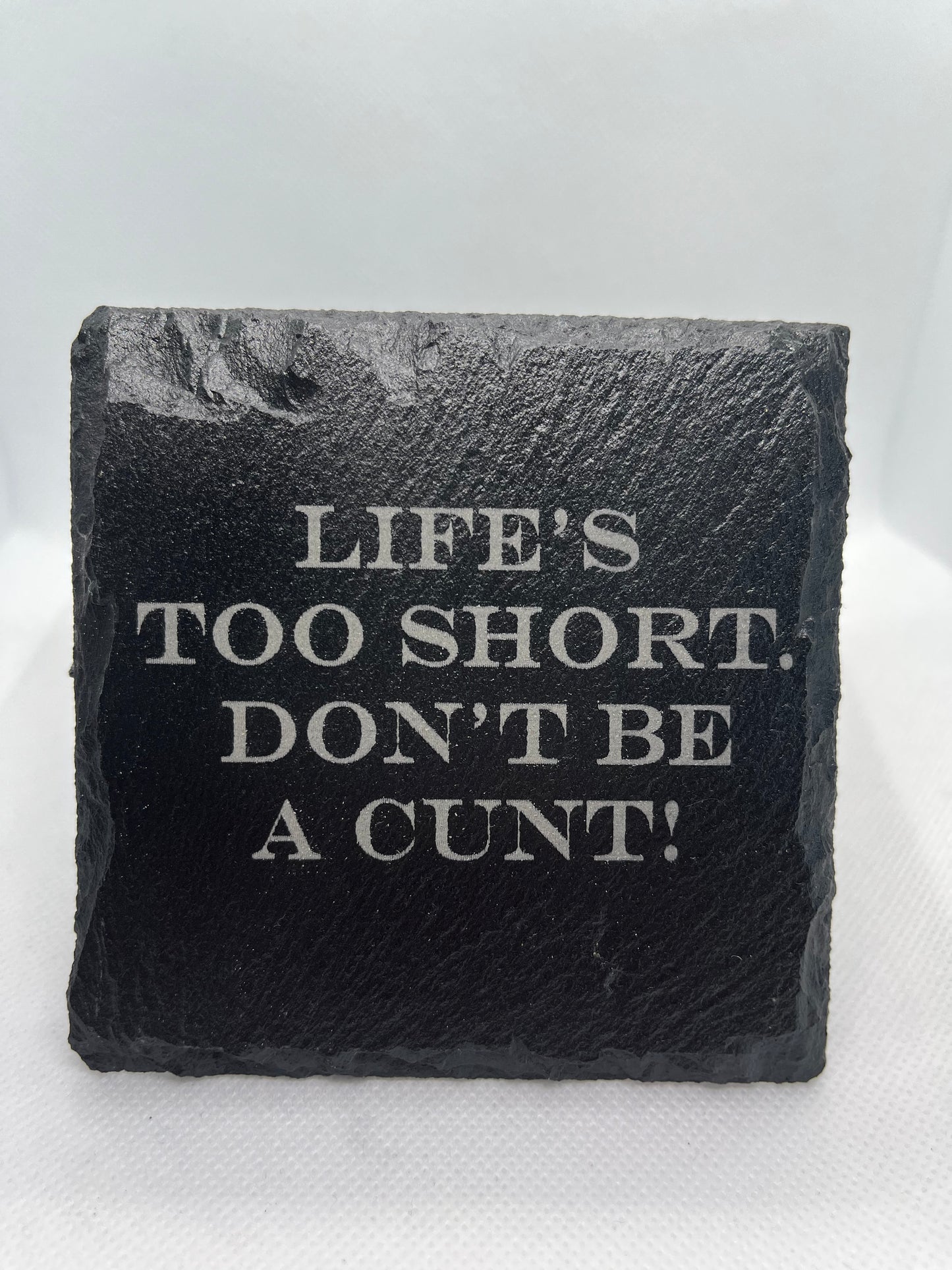 Black slate with engraved text on a white background