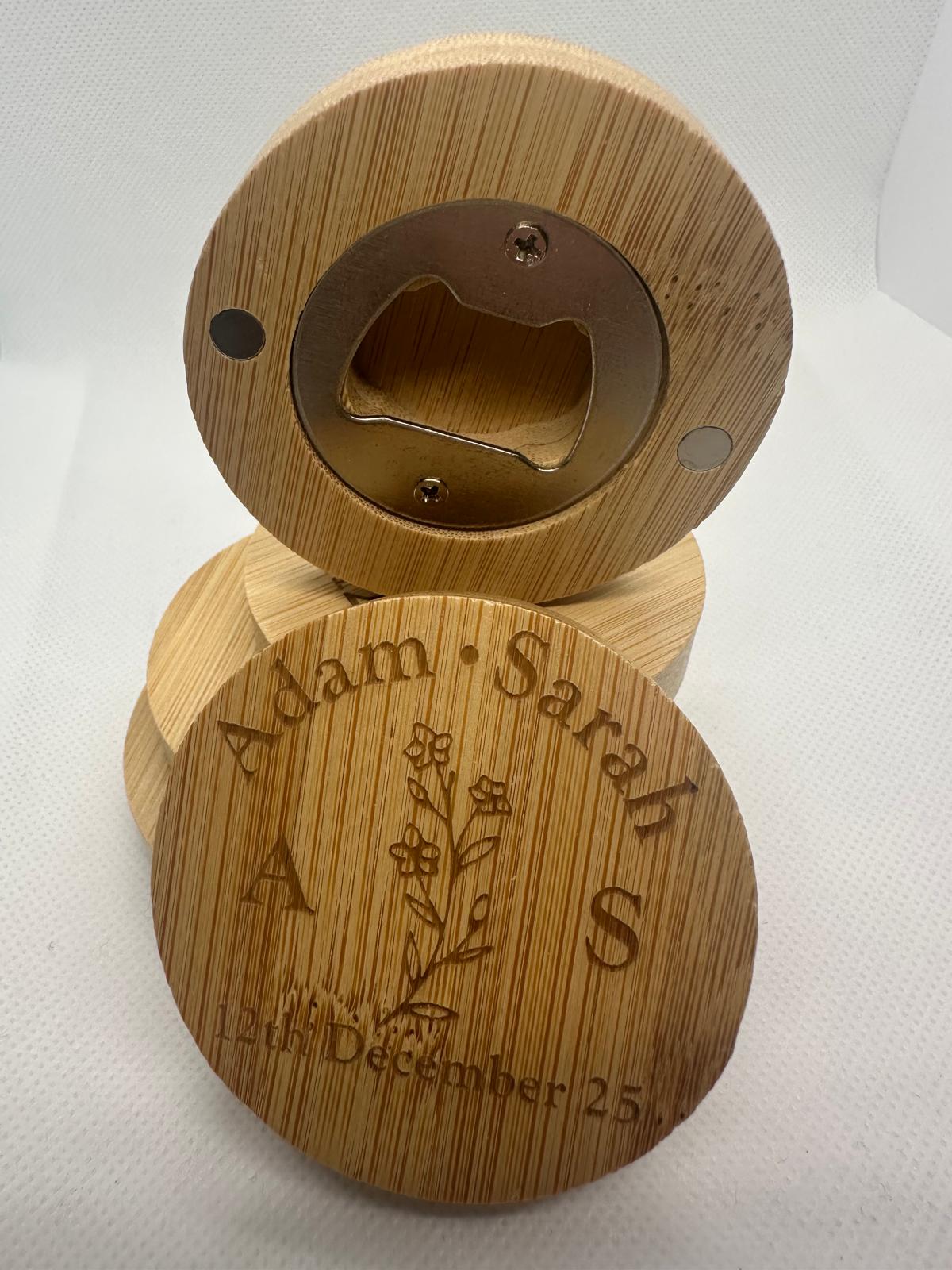 Wooden bottle opener with engraved names and date on a white background