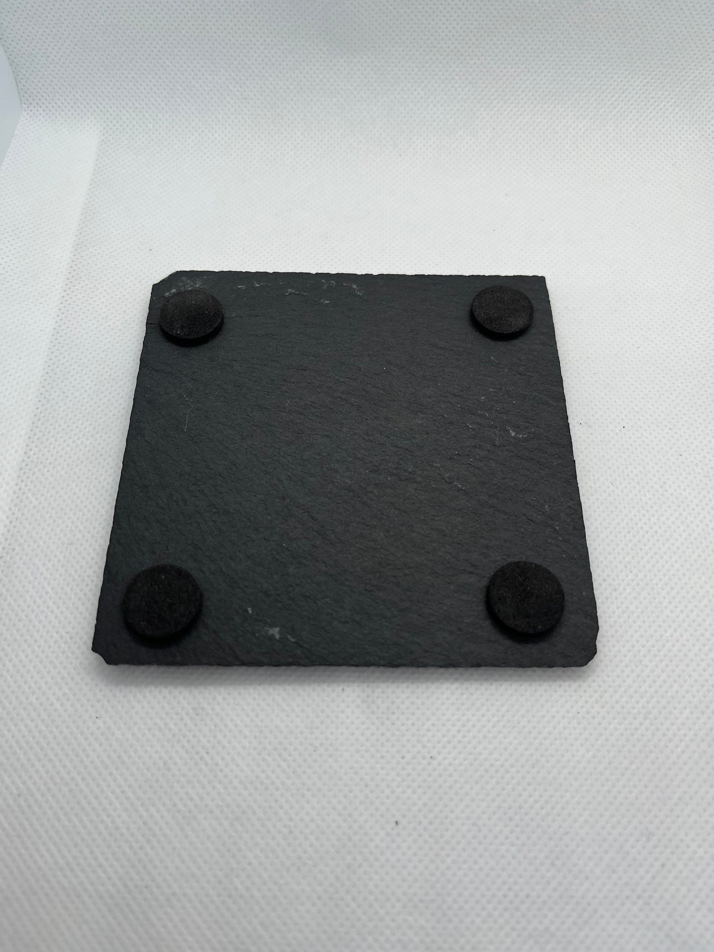 black-slate-coaster-underside-showing-four-foam-feet-pads