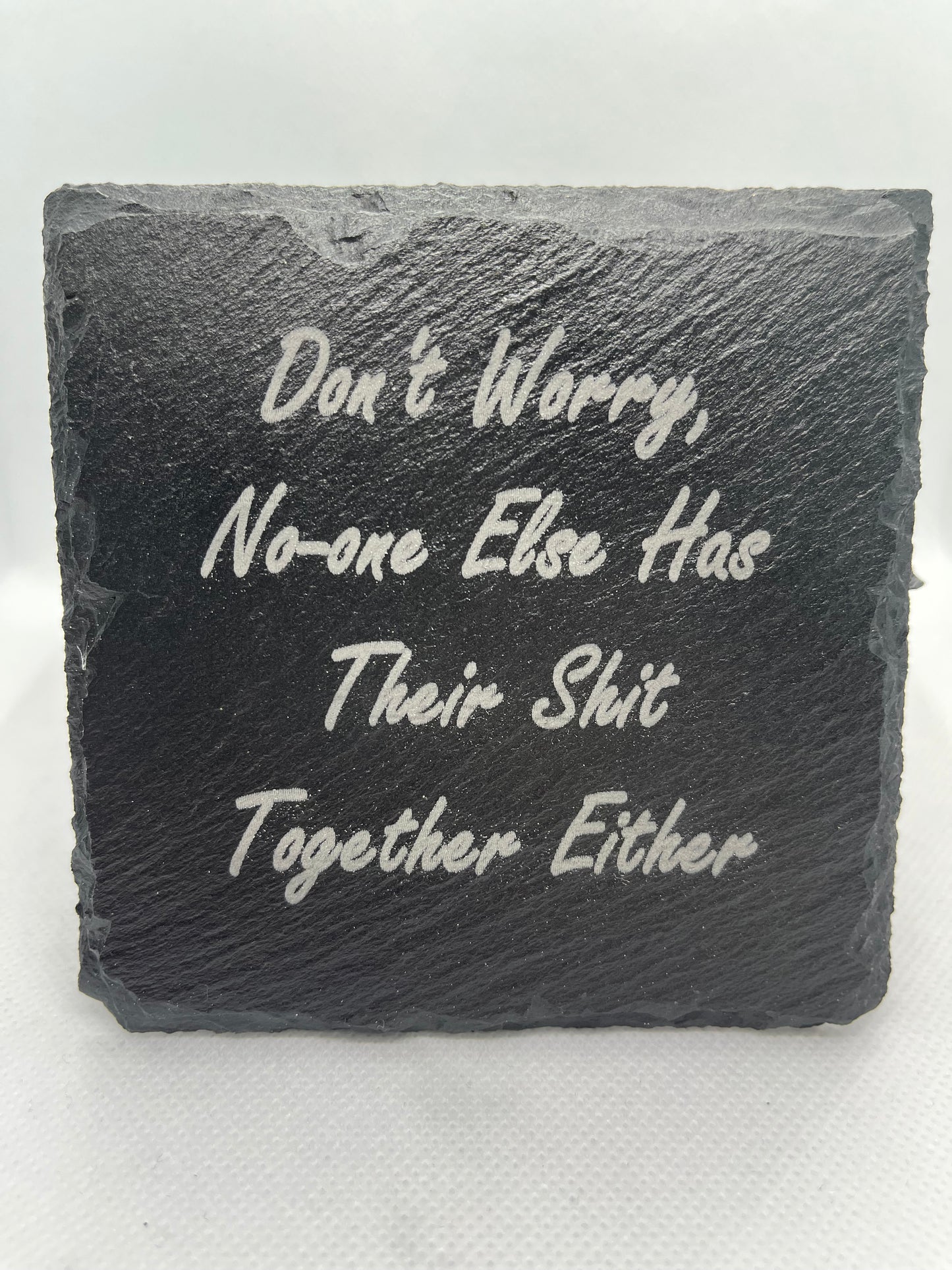 Slate stone with engraved text on a white background