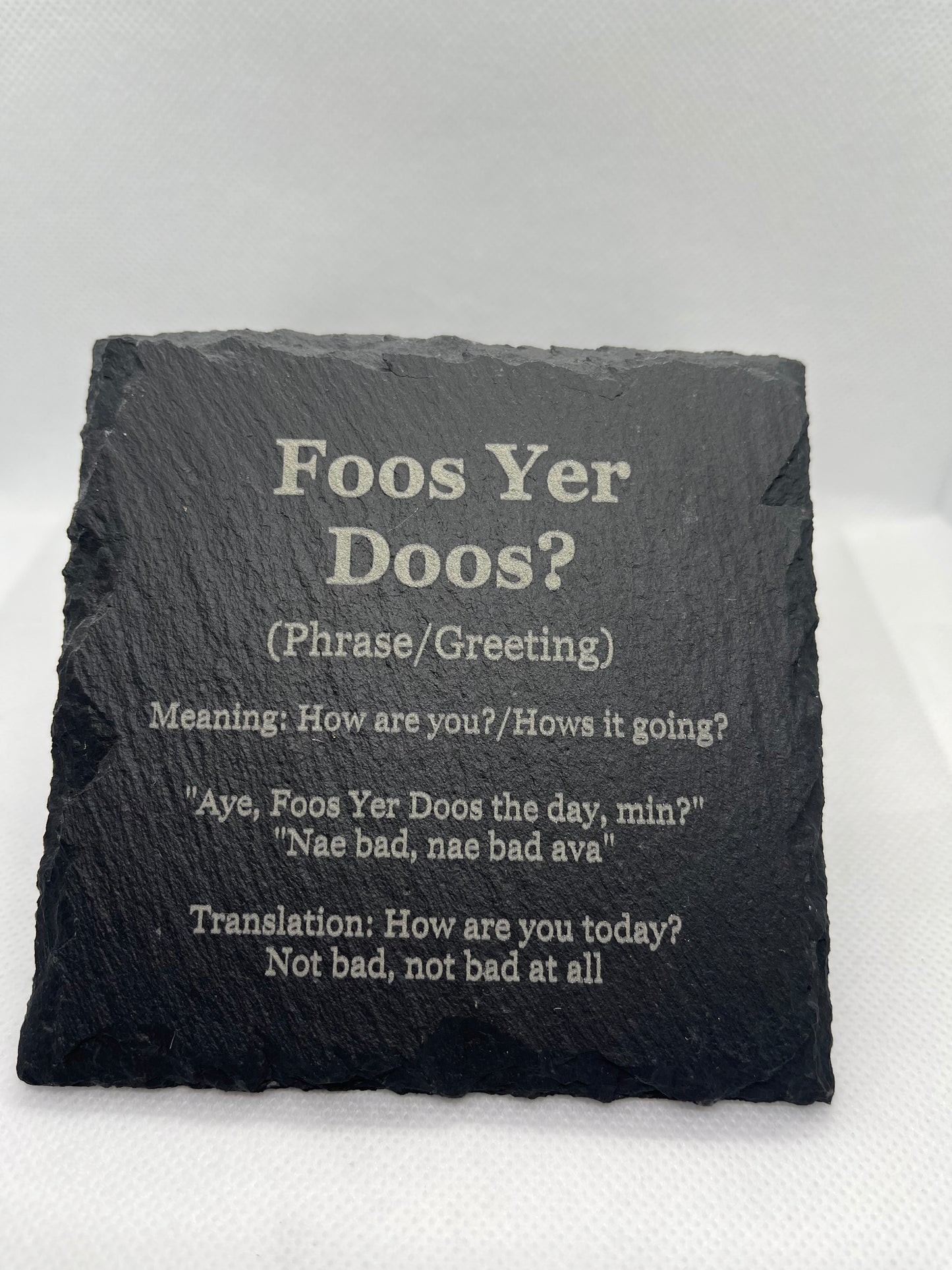 Slate coaster with Scottish phrase 'Foos Yer Doos?' and translation on a white background