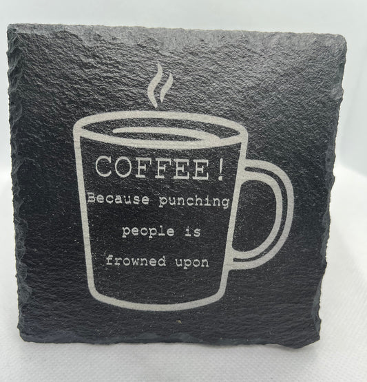 Slate coaster with coffee cup design and humorous text on a white background