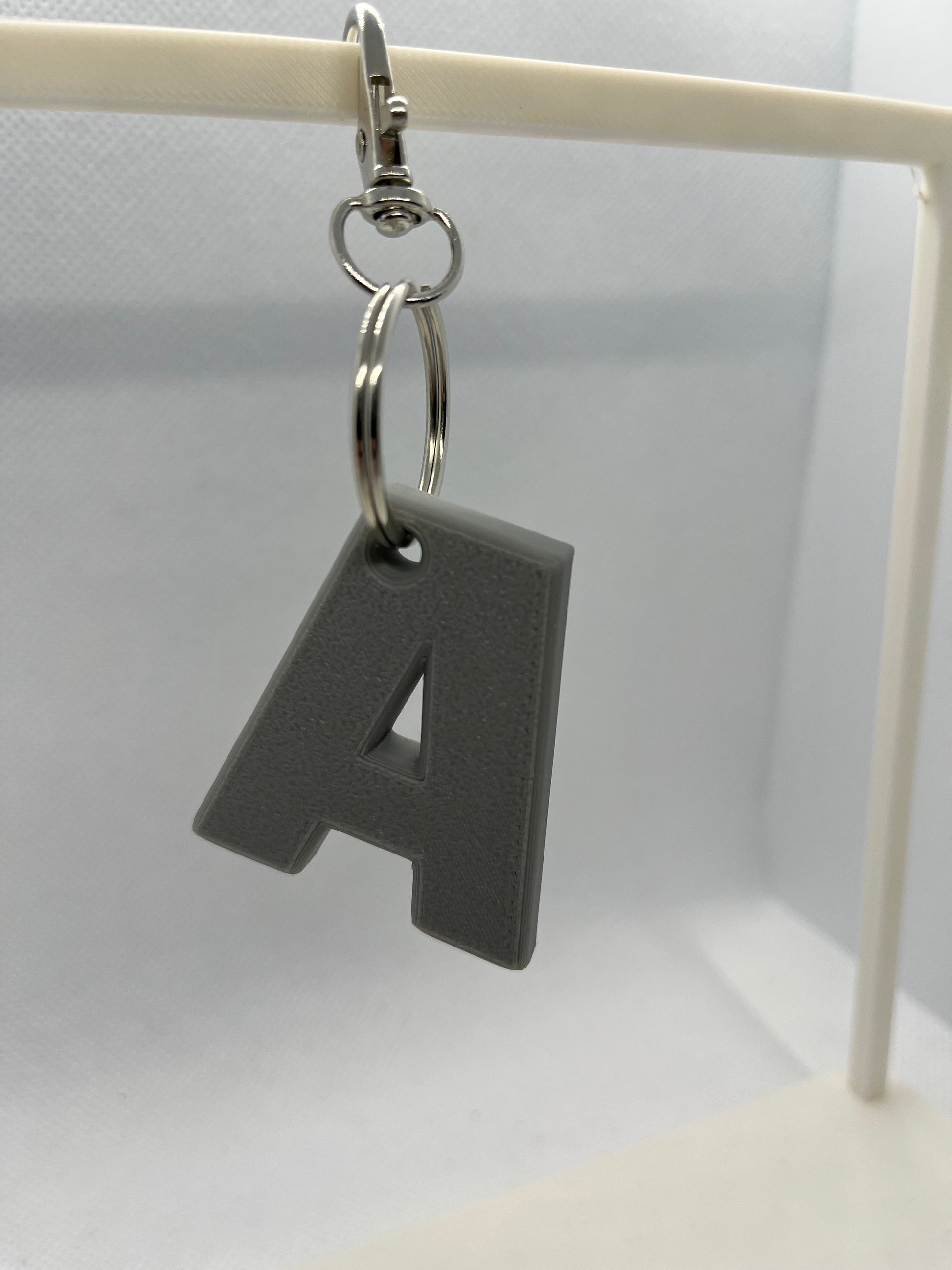 Grey Keychain with a letter 'A' on a white background