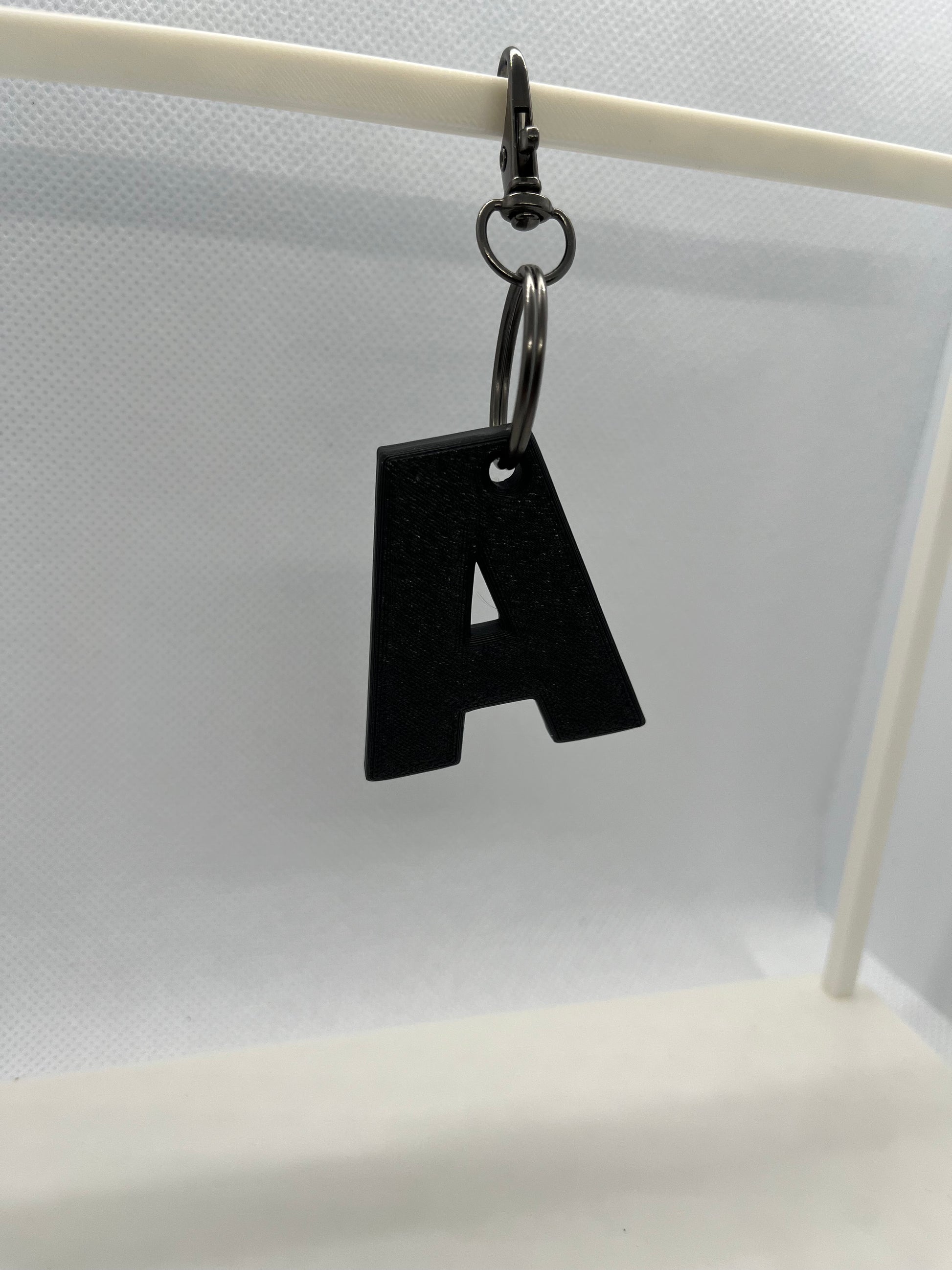 Black letter 'A' keychain on a white background