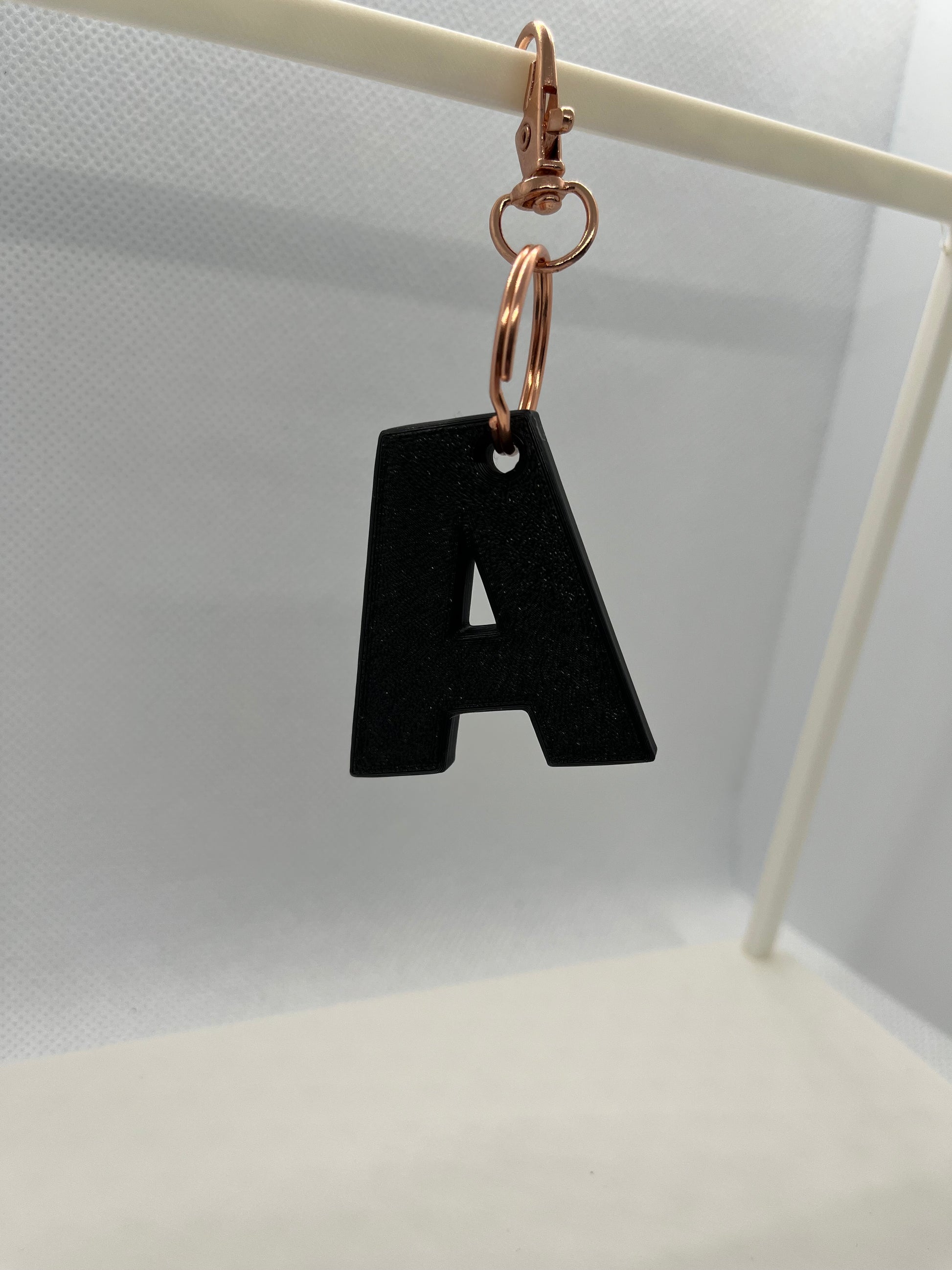Black letter 'A' keychain on a white background