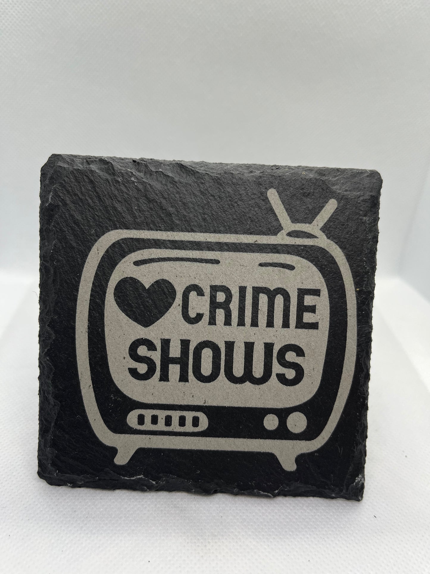 Slate coaster with 'Crime Shows' design on a white background