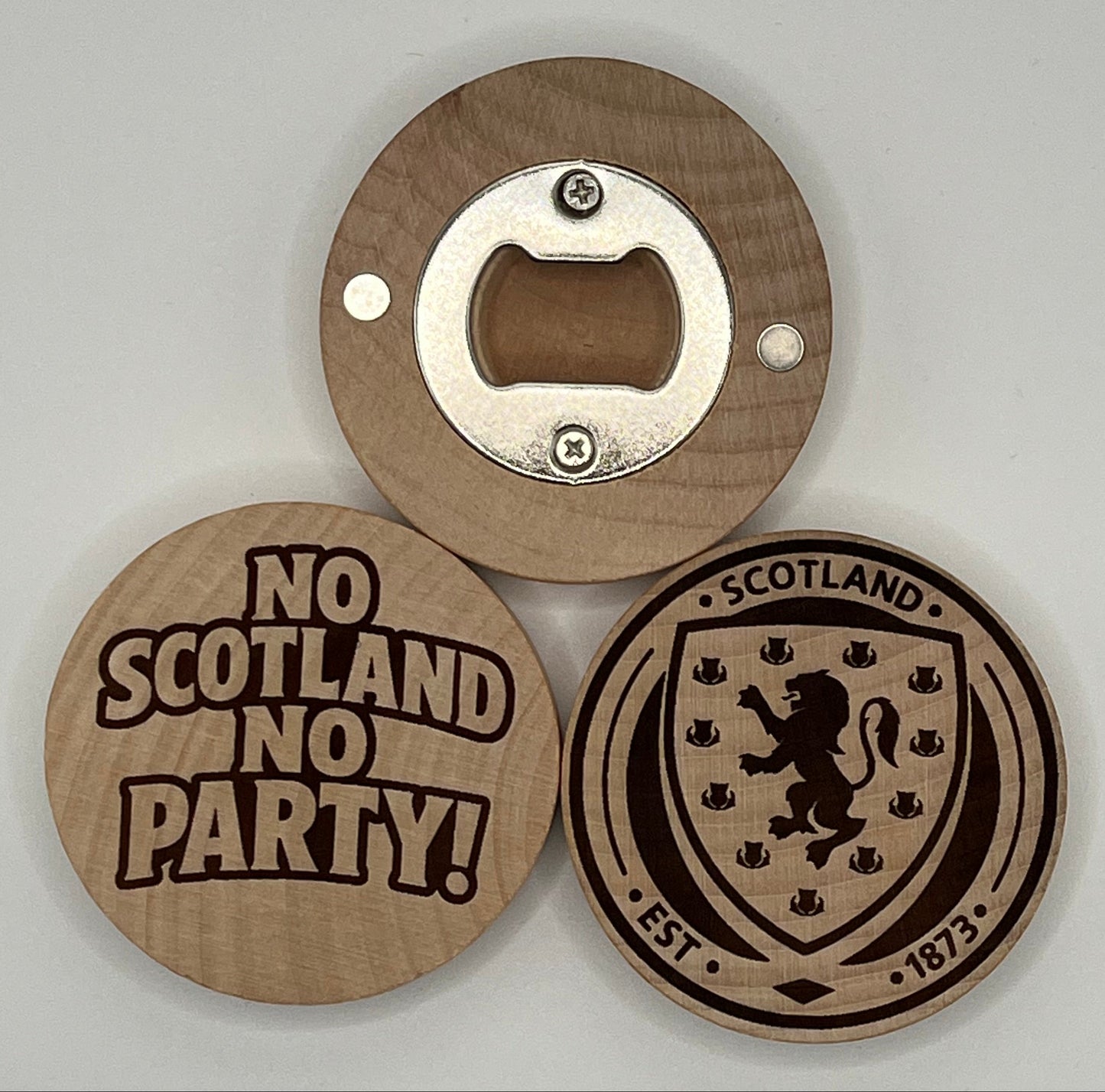 Wooden bottle opener with Scottish design on a gray background