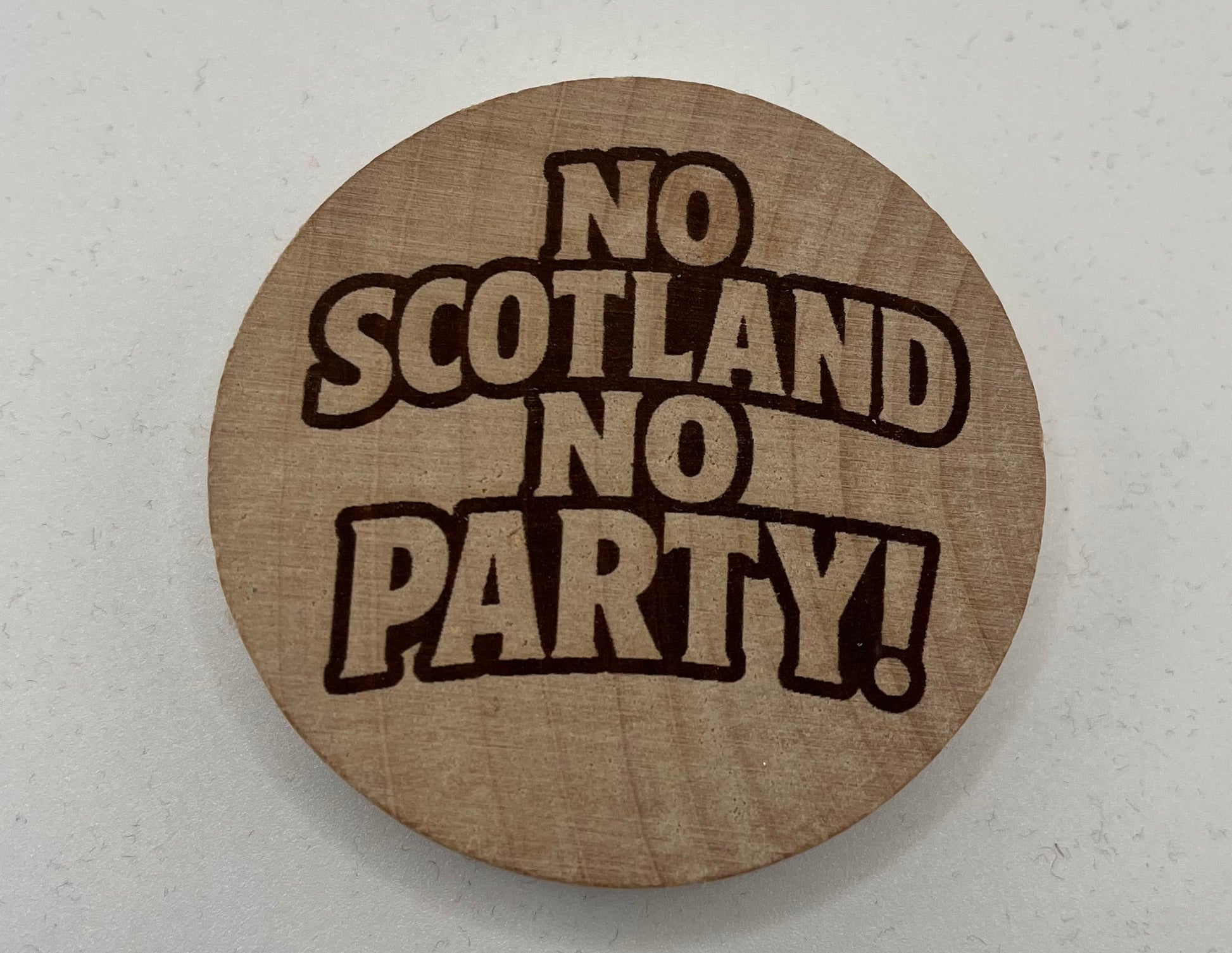 Round cardboard coaster with 'No Scotland No Party!' text on a white background