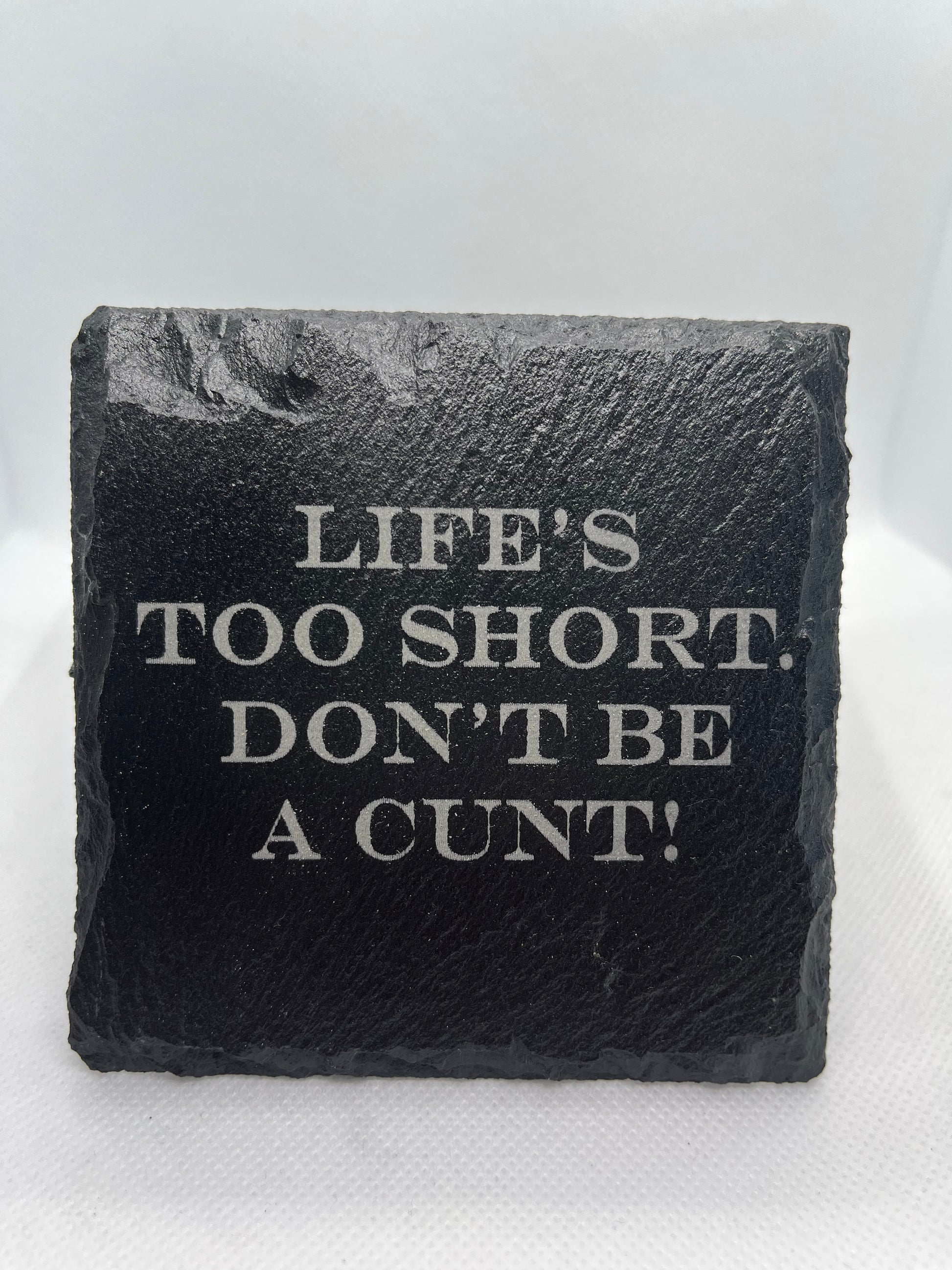 Black slate with engraved text on a white background