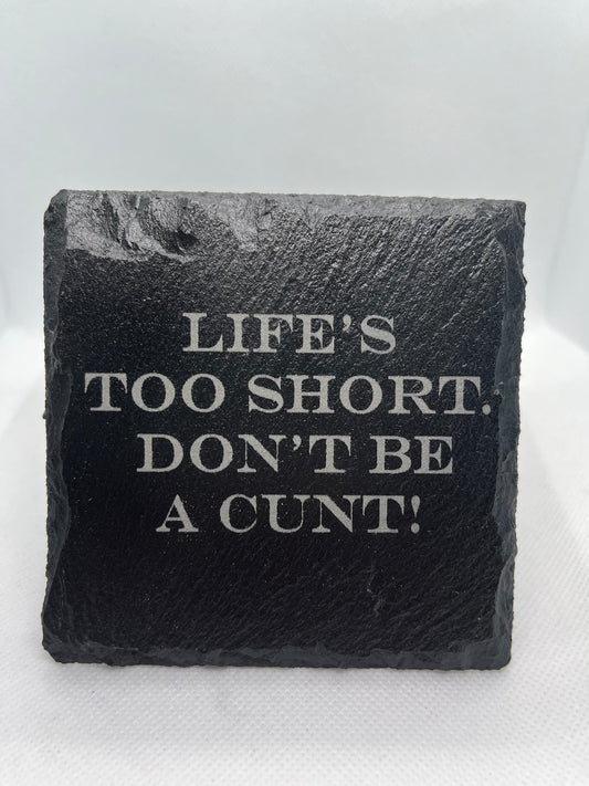 Black slate with engraved text on a white background