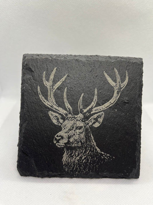 Slate coaster with a deer design on a white background