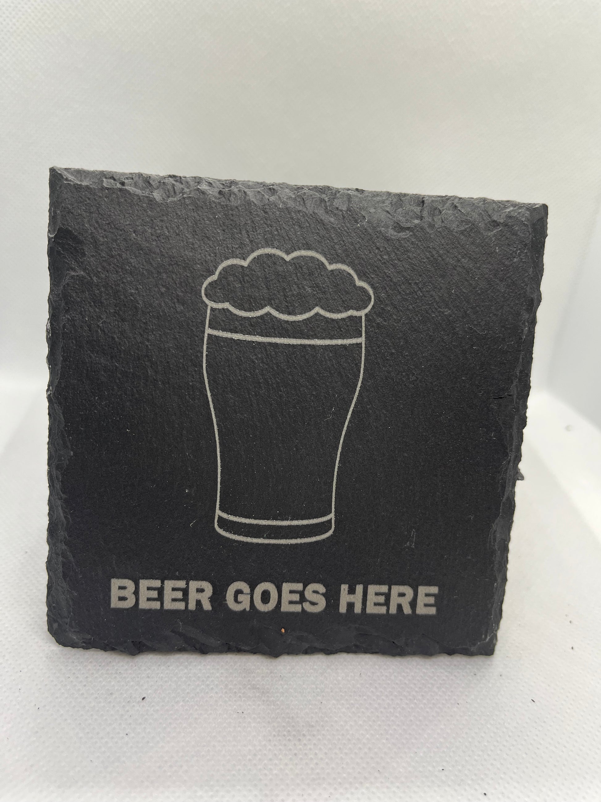 Slate coaster with a beer glass illustration and 'Beer Goes Here' text on a white background