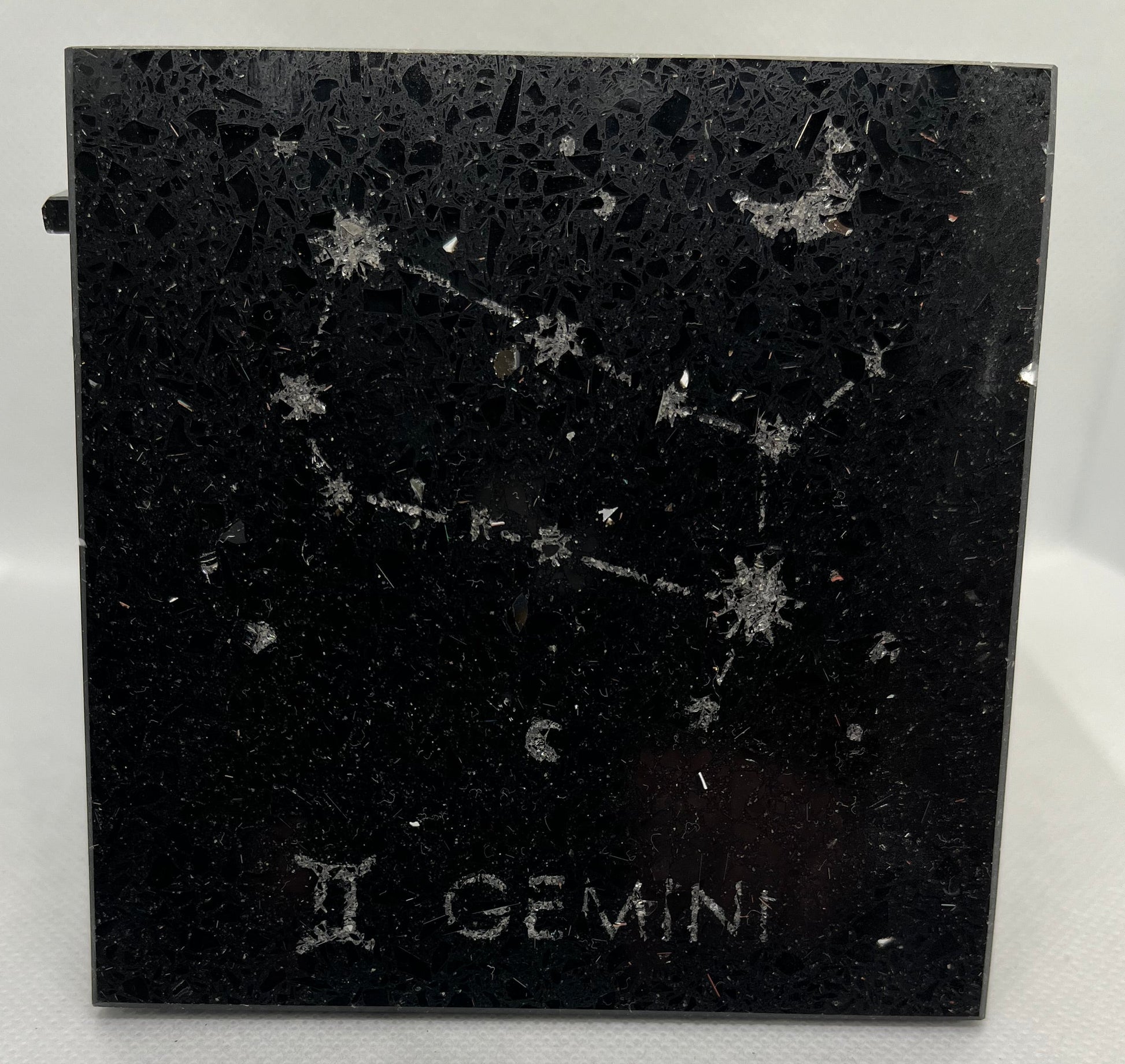 Black square with star constellation design and 'Gemini' text on a white background