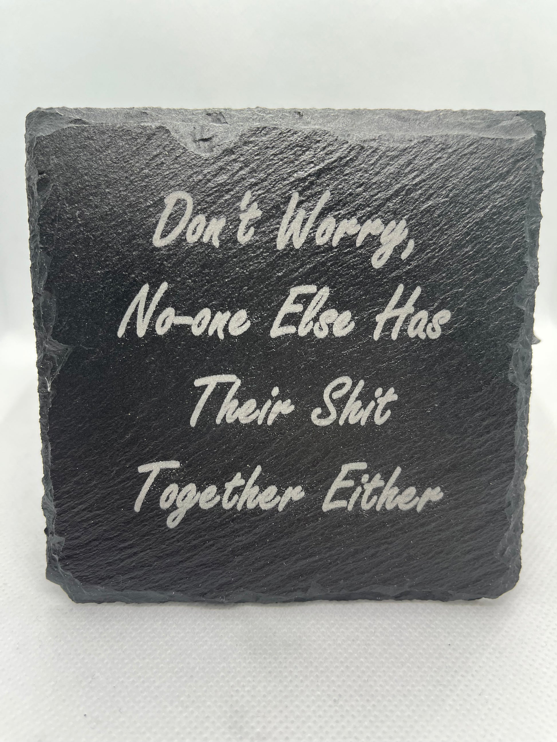 Slate stone with engraved text on a white background