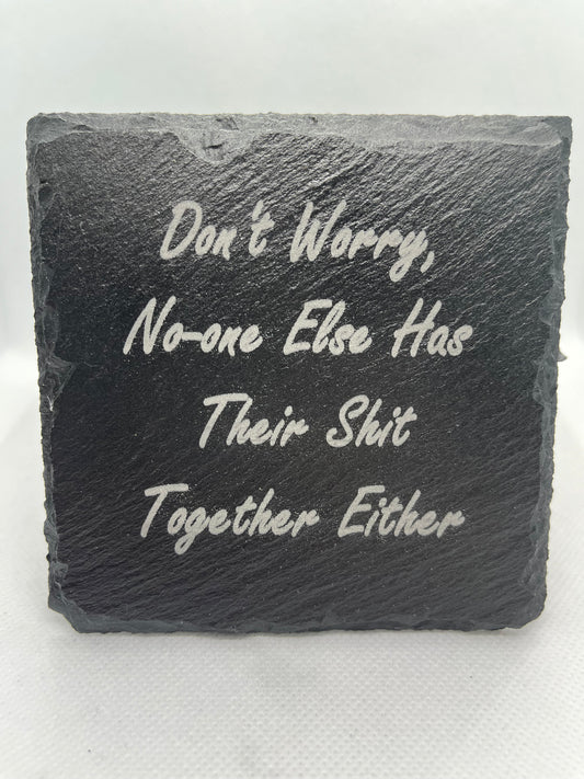 Slate stone with engraved text on a white background
