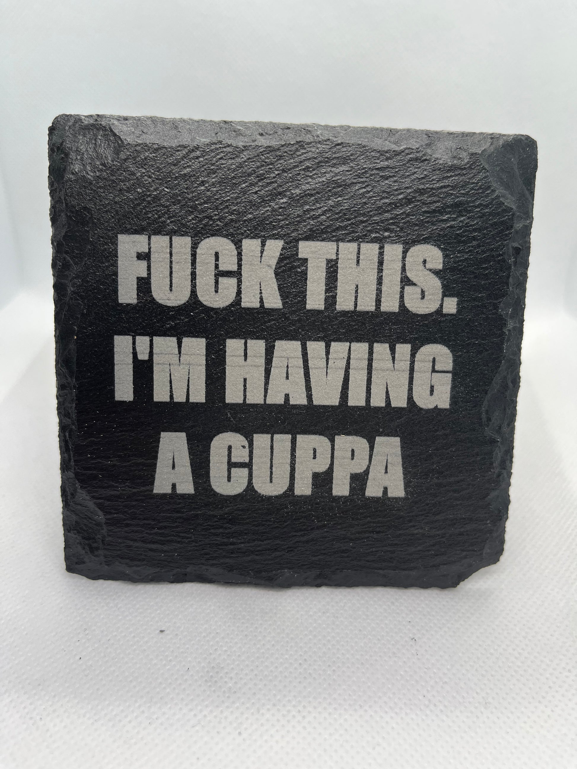 Slate coaster with printed text on a white background