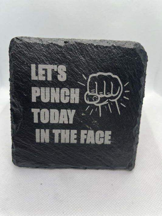 Slate coaster with engraved text and fist graphic on a white background