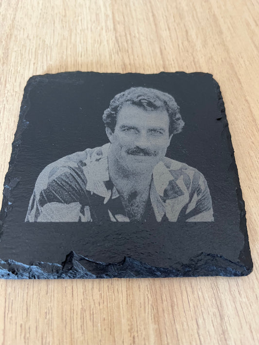 Engraved photo of a man on a dark slate stone