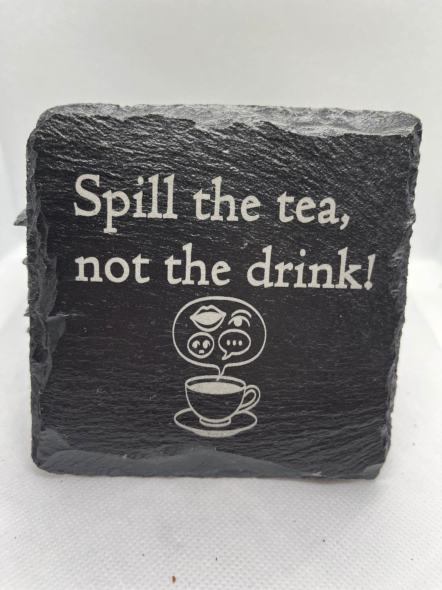 Slate coaster with humorous text and tea cup illustration on a white background