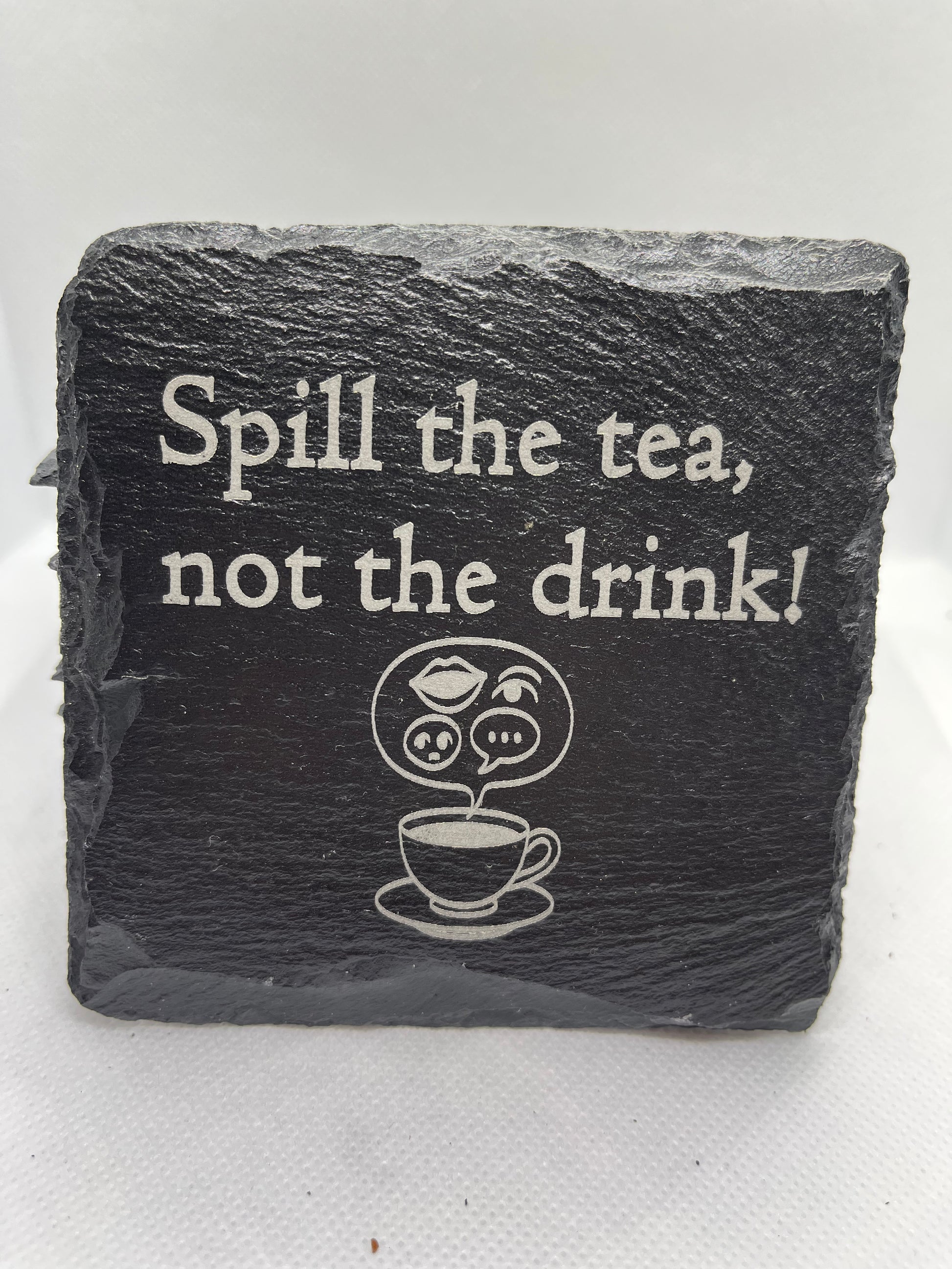 Slate coaster with humorous text and tea cup illustration on a white background